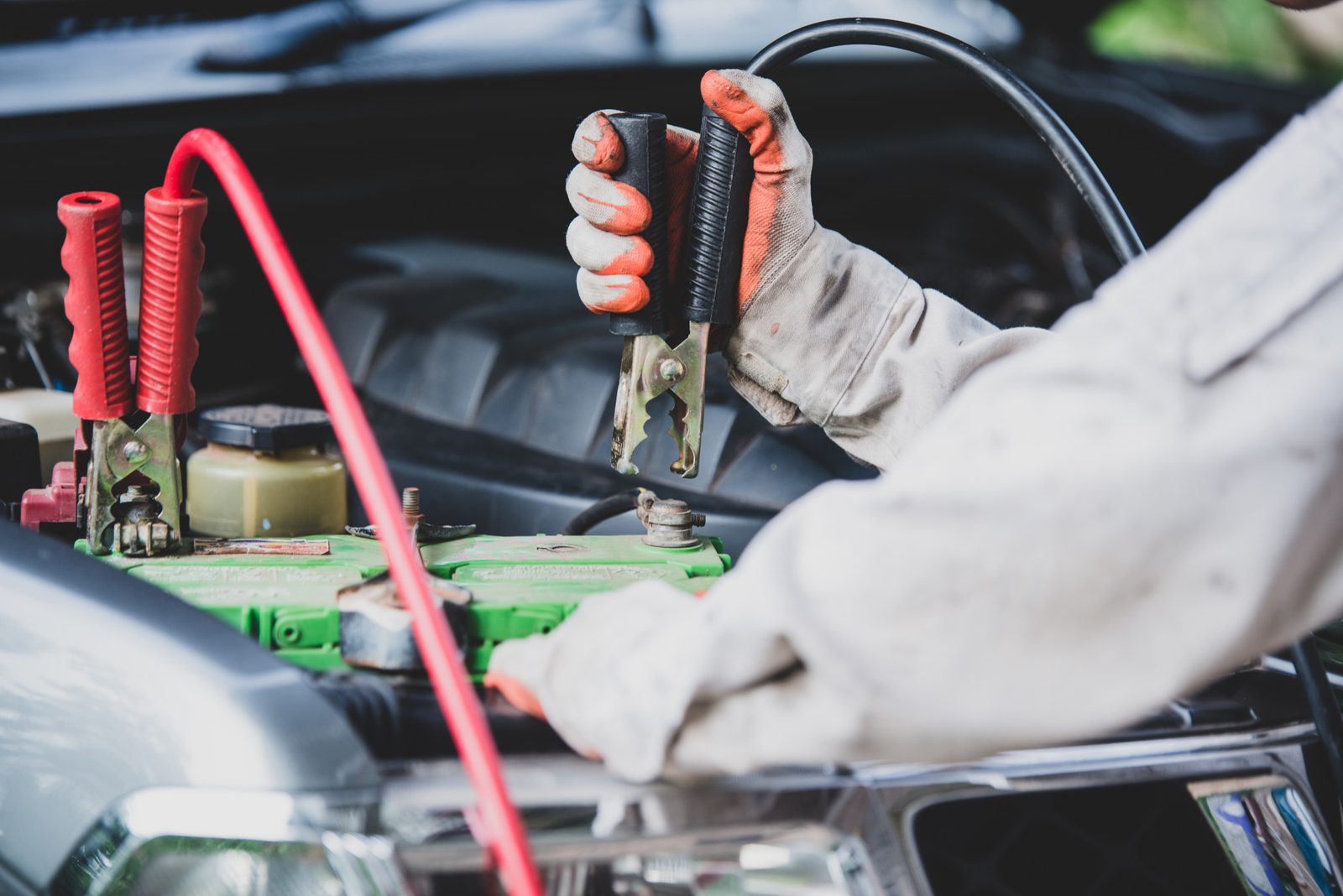 Jump leads clamped to a car battery during a car electrical check